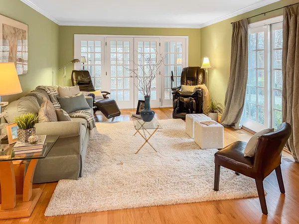 a living room with furniture and large windows