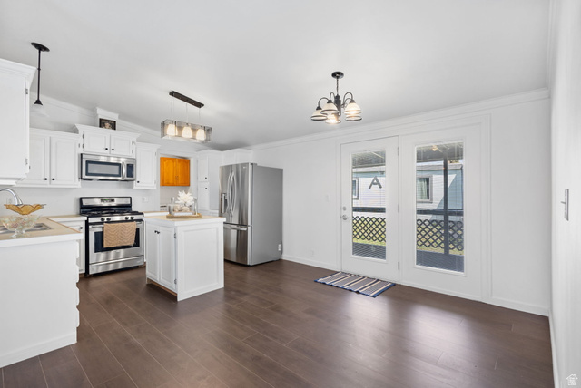 2600 North Hill Field Road, Unit 86 Layton, UT 84041 - Photo 5 of 25 Kitchen featuring light countertops, white cabinetry, a kitchen island, stainless steel appliances, and a chandelier