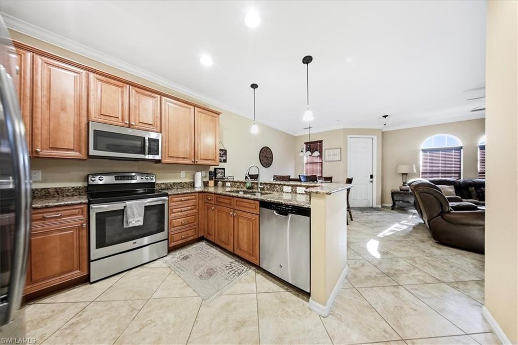 9063 Capistrano Street North, Unit 4401 Naples, FL 34113 - Photo 13 of 50 a kitchen with granite countertop a stove top oven a sink dishwasher and a refrigerator