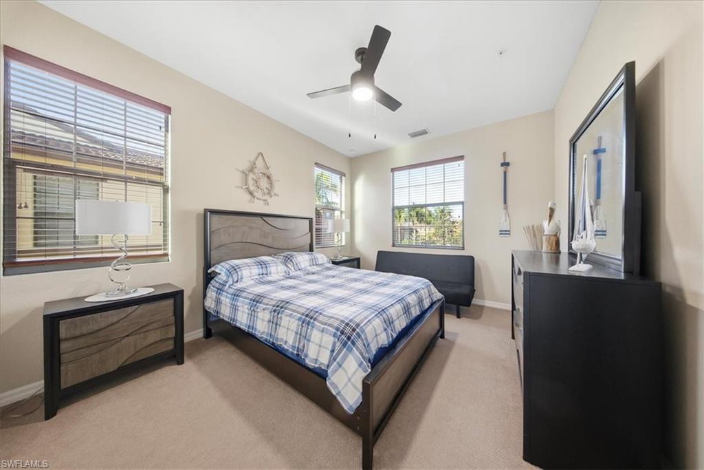 9063 Capistrano Street North, Unit 4401 Naples, FL 34113 - Photo 28 of 50 a bedroom with a large bed and a window