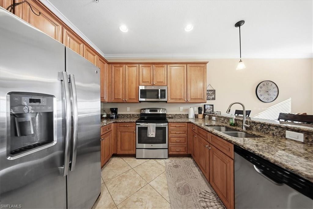 9063 Capistrano Street North, Unit 4401 Naples, FL 34113 - Photo 30 of 50 a kitchen with granite countertop stainless steel appliances and a sink