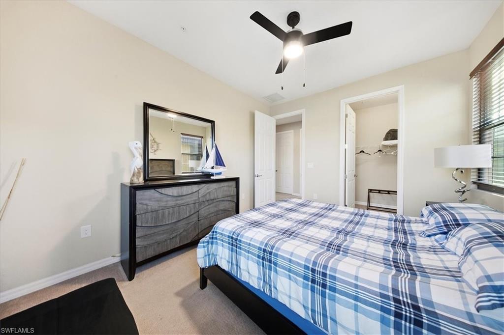 9063 Capistrano Street North, Unit 4401 Naples, FL 34113 - Photo 34 of 50 a bedroom with a bed and a dresser