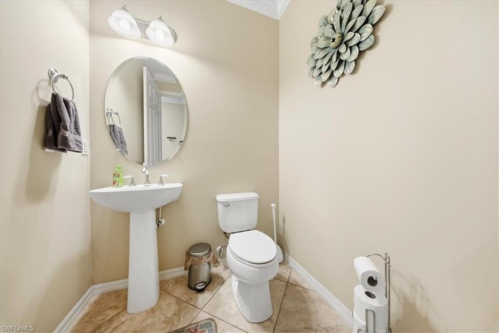 9063 Capistrano Street North, Unit 4401 Naples, FL 34113 - Photo 35 of 50 a bathroom with a toilet sink and mirror
