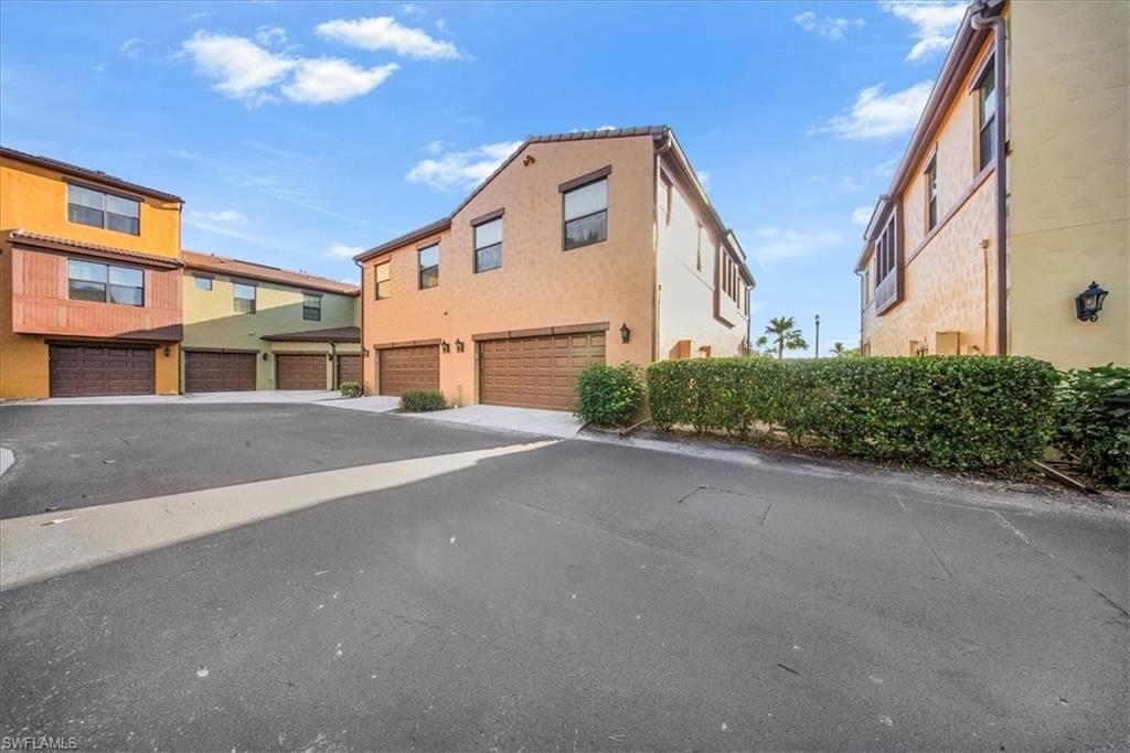 9063 Capistrano Street North, Unit 4401 Naples, FL 34113 - Photo 40 of 50 a front view of a building with a street