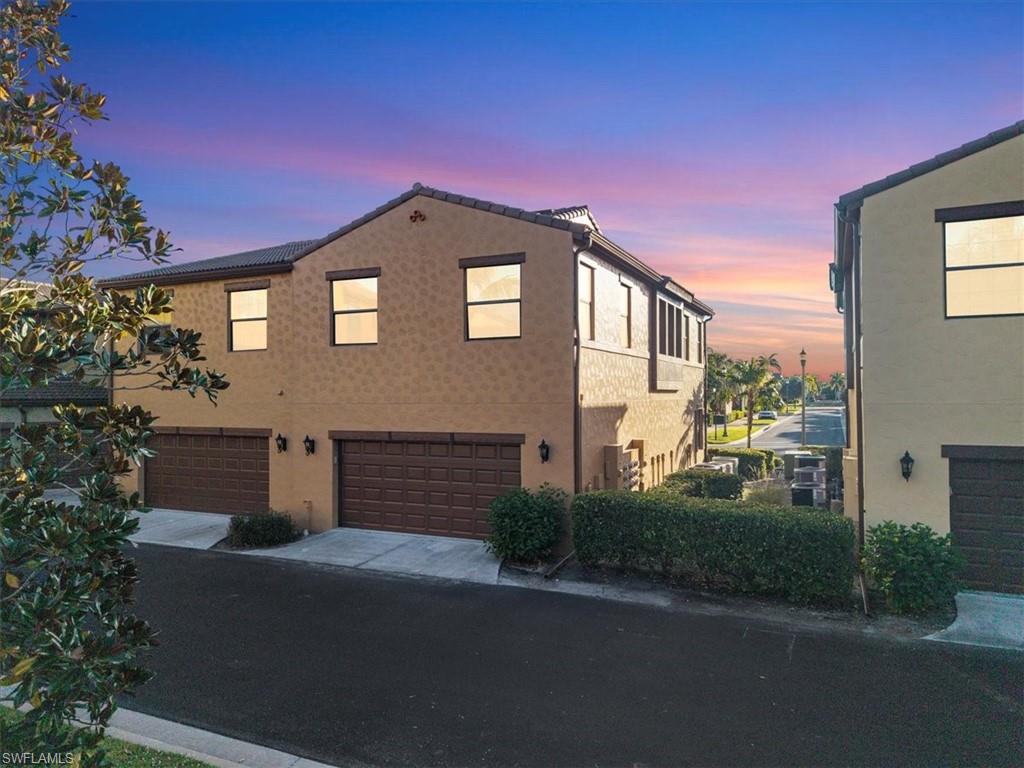 9063 Capistrano Street North, Unit 4401 Naples, FL 34113 - Photo 4 of 50 a front view of a house with a yard