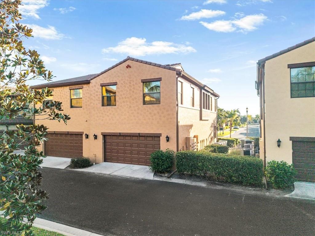 9063 Capistrano Street North, Unit 4401 Naples, FL 34113 - Photo 7 of 50 a view of a house with a yard