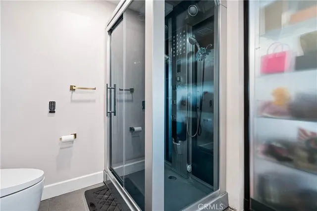 a bathroom with a glass shower door
