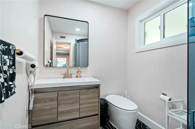 a bathroom with a sink toilet and mirror