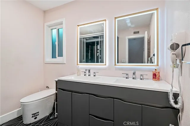 a bathroom with a toilet sink and mirror