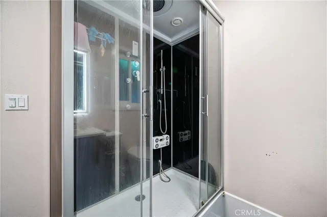 a bathroom with a shower and a sink