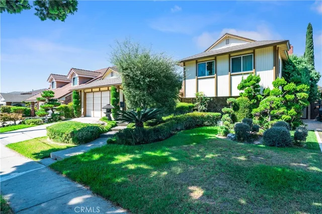 a front view of a house with a garden