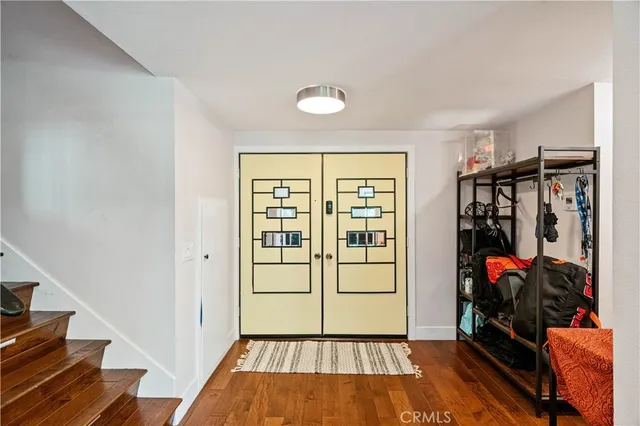 a view of a hallway with wooden floor and a window