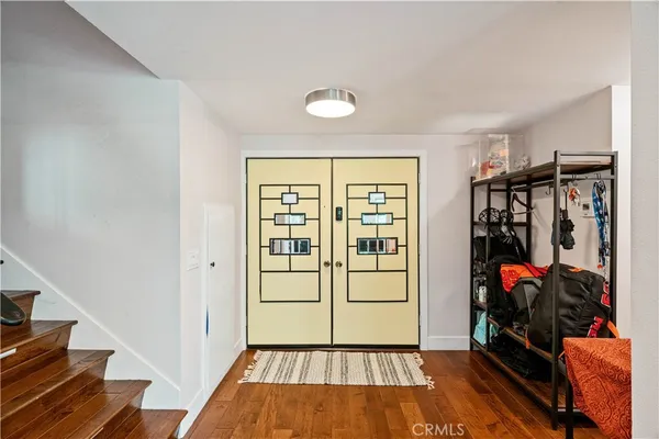 a view of a hallway with wooden floor and a window