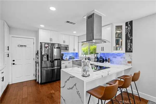 a kitchen with refrigerator and cabinets