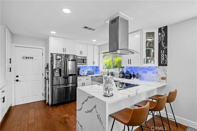 a kitchen with refrigerator and cabinets