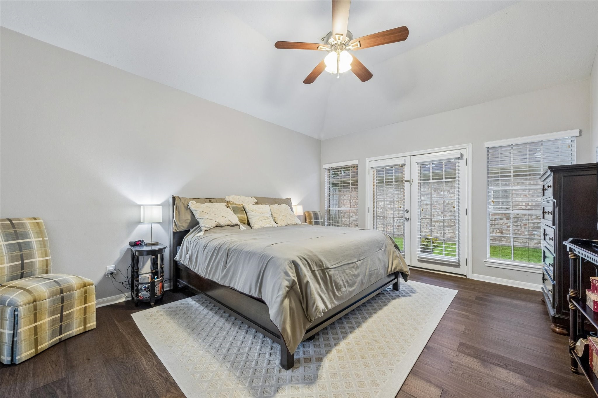 12423 Rutgers Park Court Houston, TX 77058 - Photo 23 of 29 a bedroom with a large bed a flat tv screen and a dresser