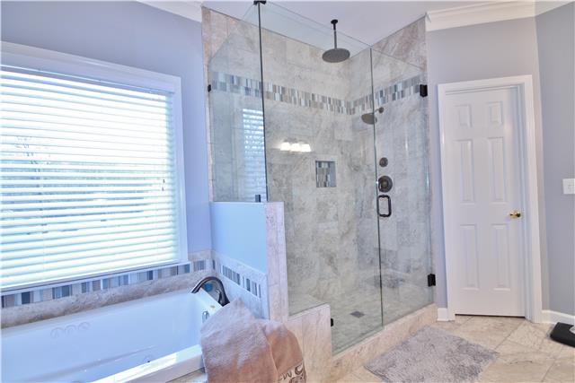 8213 Spring Ridge Drive Nashville, TN 37221 - Photo 11 of 20 What a GORGEOUS spa-like master bathroom! Newly renovated, you will enjoy a double vanity, separate jetted tub and shower, and a large walk-in closet.