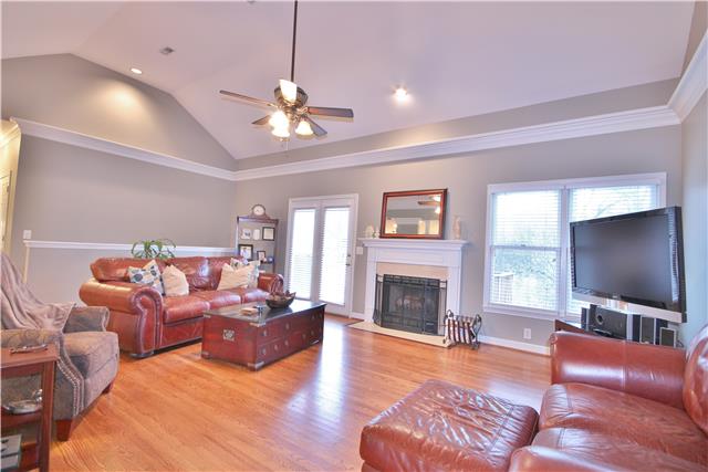 8213 Spring Ridge Drive Nashville, TN 37221 - Photo 5 of 20 The large living room has a fireplace and high gabled ceiling. The upper deck can be accessed through the French doors for outdoor entertainment.