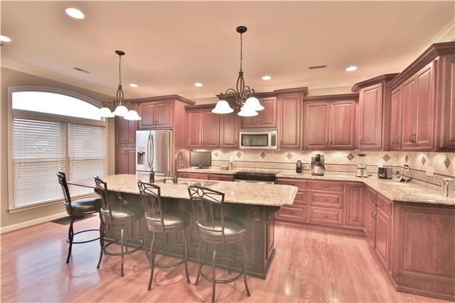 8213 Spring Ridge Drive Nashville, TN 37221 - Photo 8 of 20 The BEAUTIFULLY renovated kitchen includes custom maple cabinets, lovely granite and new appliances.