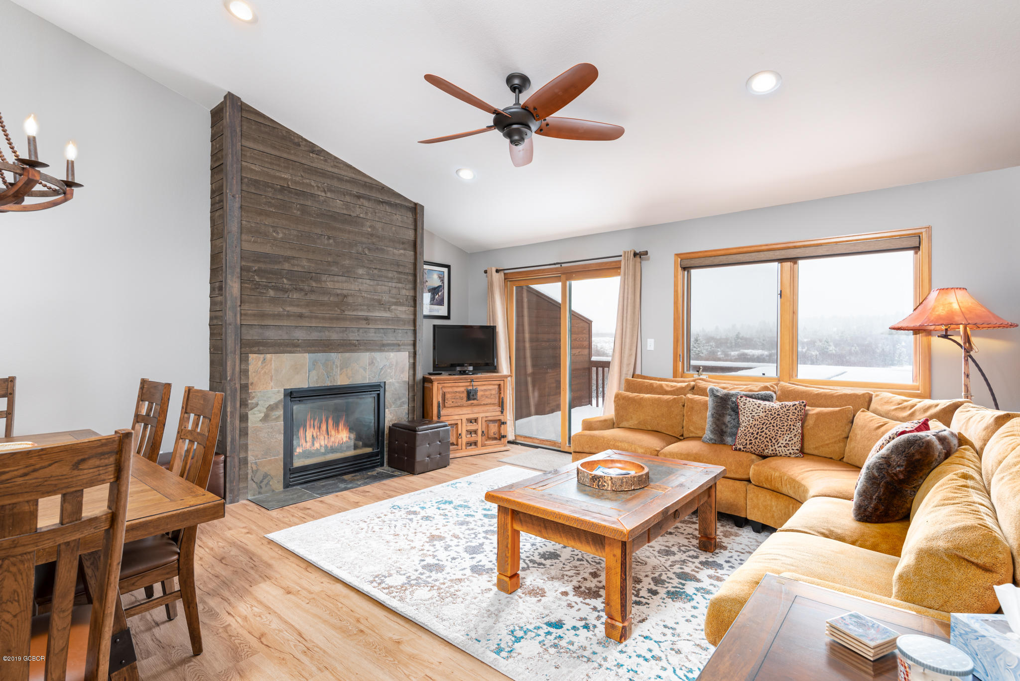 443 Muse Drive, Unit 2 Fraser, CO 80442 - Photo 1 of 26 a living room with furniture a fireplace and a large window