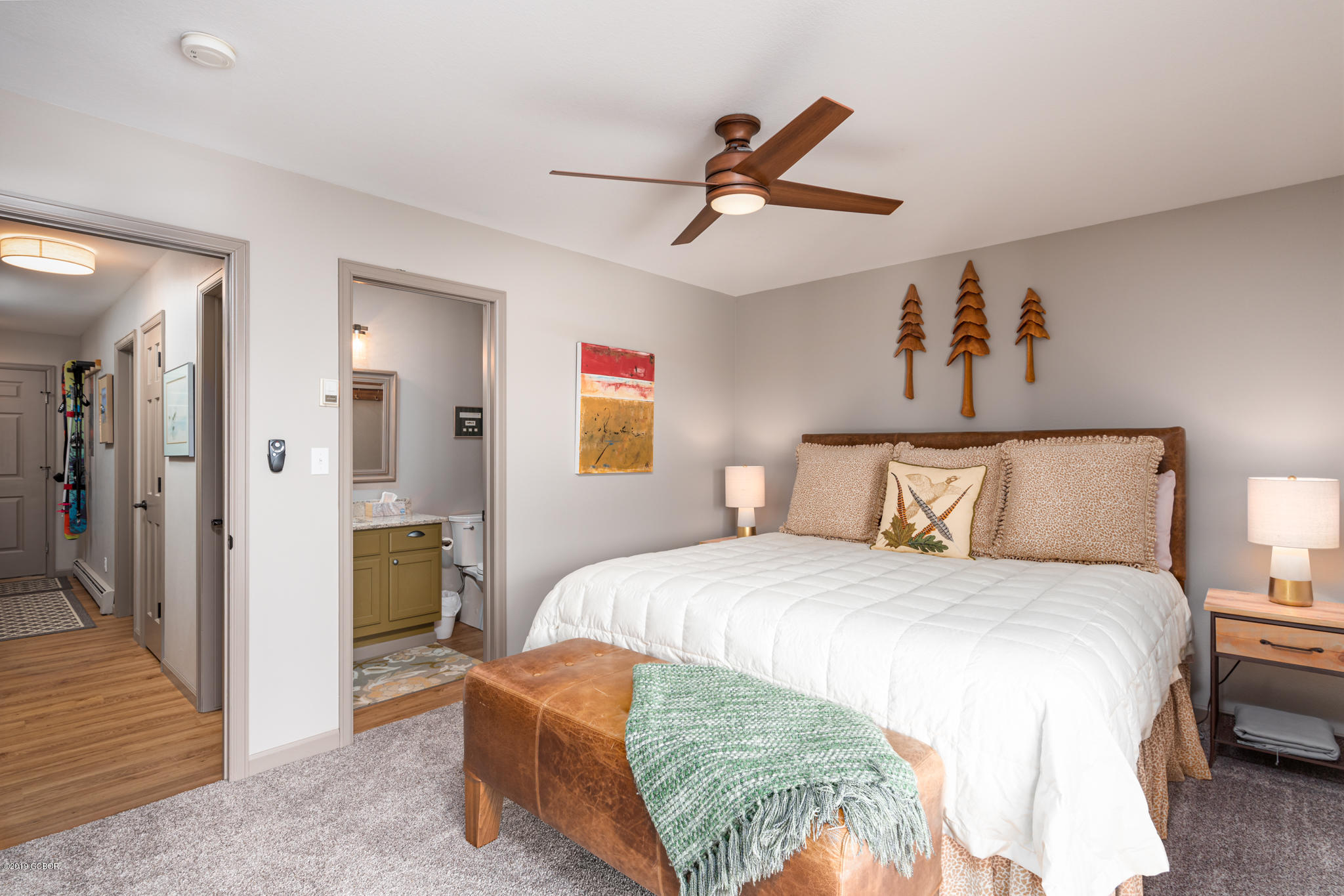 443 Muse Drive, Unit 2 Fraser, CO 80442 - Photo 13 of 26 a bedroom with a bed and a chandelier