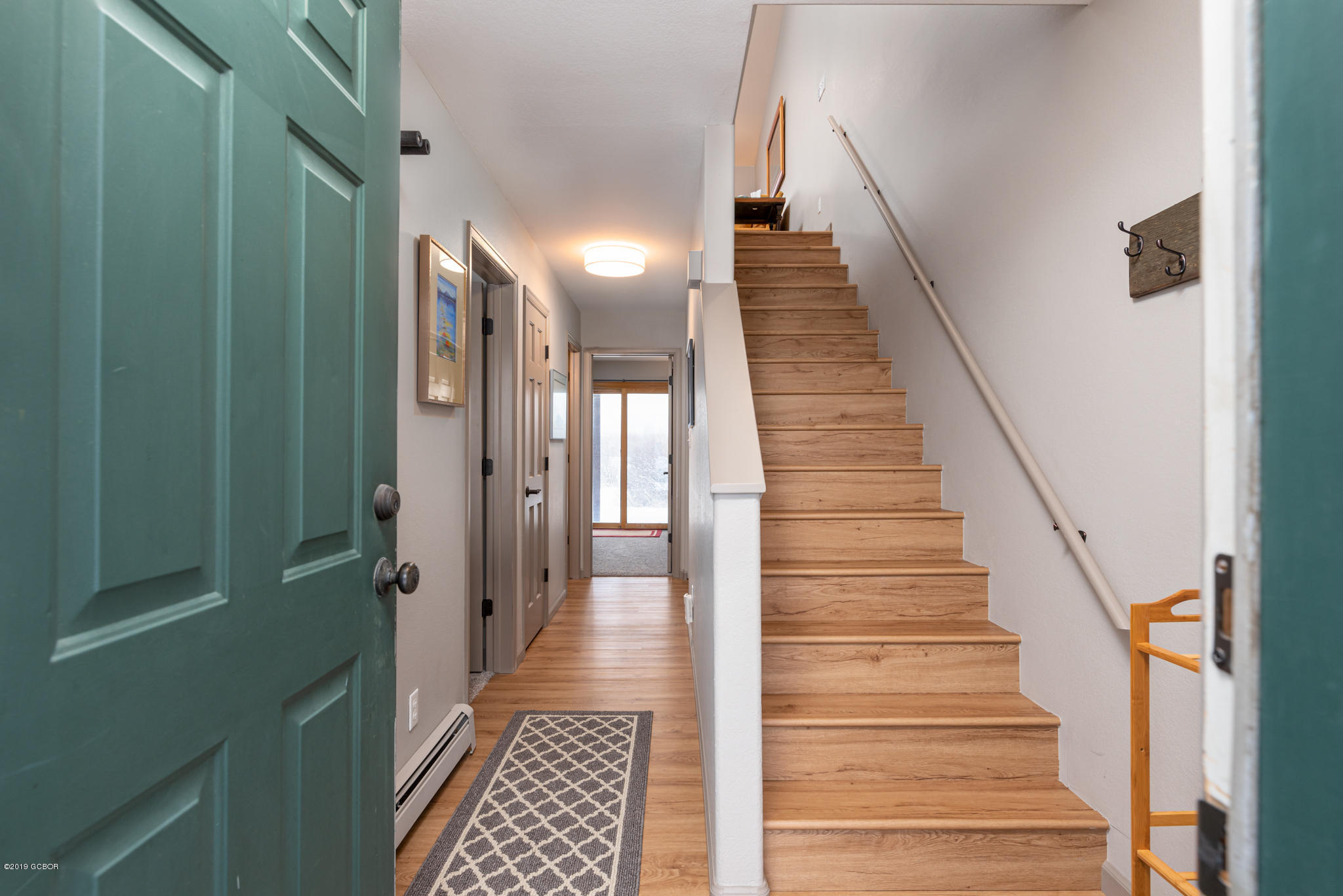 443 Muse Drive, Unit 2 Fraser, CO 80442 - Photo 3 of 26 a view of a hallway with wooden floor and stairs