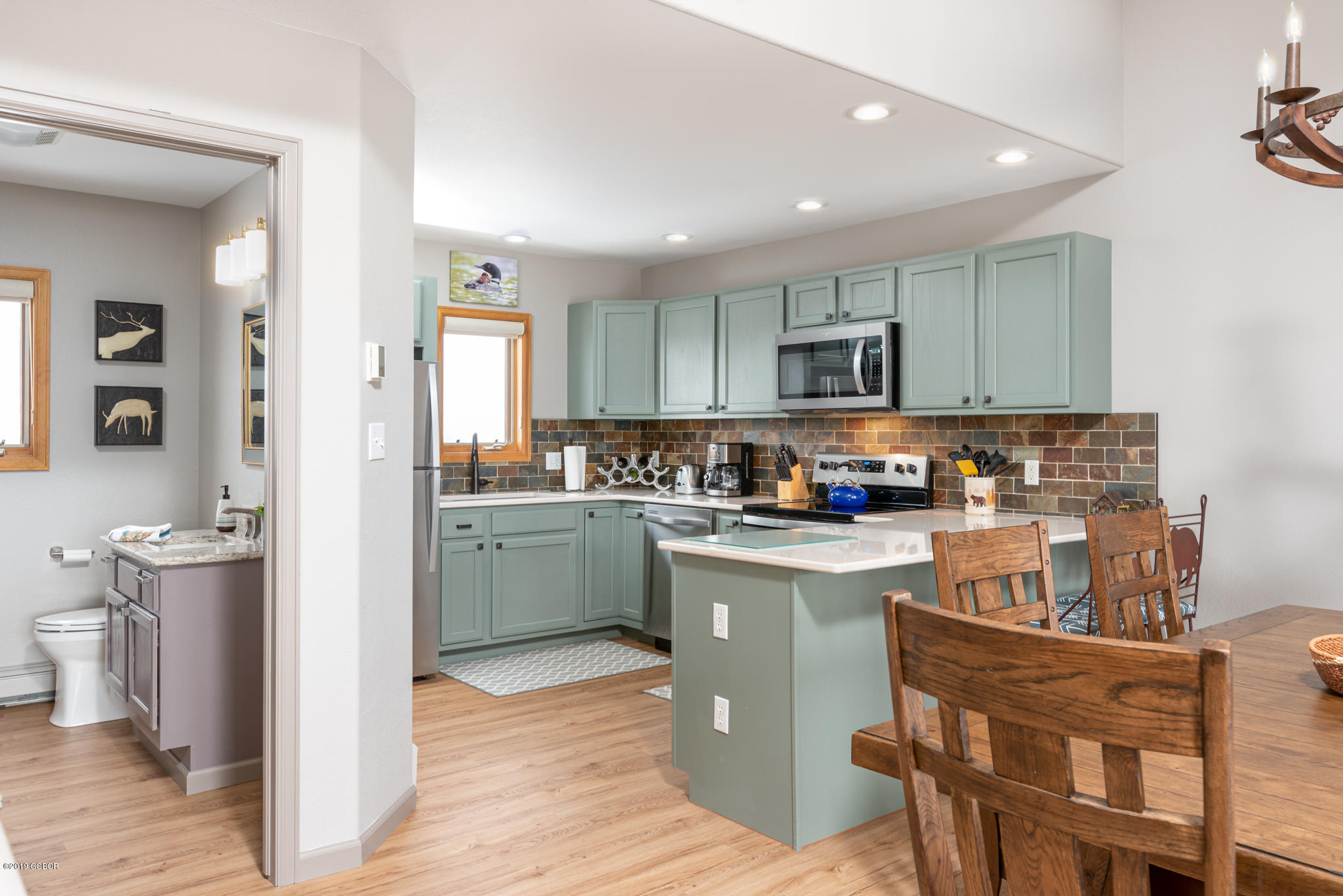 443 Muse Drive, Unit 2 Fraser, CO 80442 - Photo 6 of 26 a kitchen with a refrigerator and a stove top oven