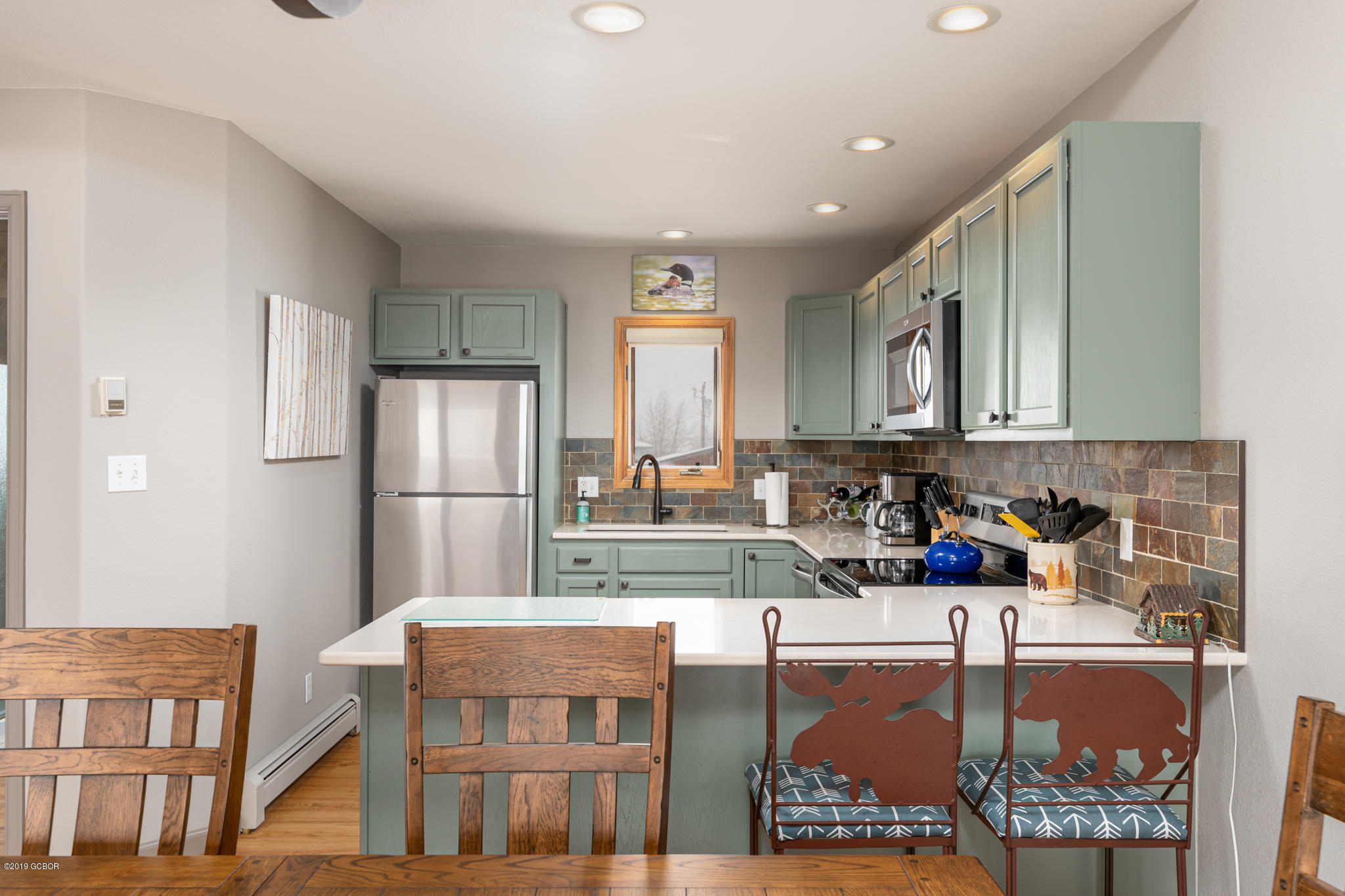 443 Muse Drive, Unit 2 Fraser, CO 80442 - Photo 7 of 26 a kitchen with stainless steel appliances granite countertop a refrigerator and a stove top oven