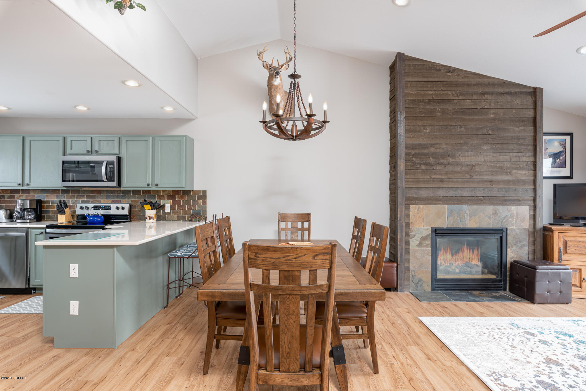 443 Muse Drive, Unit 2 Fraser, CO 80442 - Photo 8 of 26 a kitchen with stainless steel appliances granite countertop a stove top oven a sink a dining table and chairs