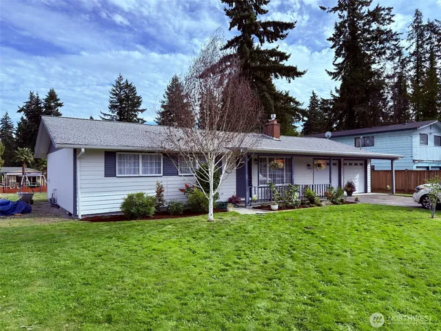 a view of a house with a yard and sitting area