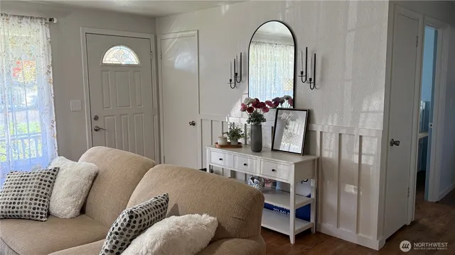 a living room with furniture and a mirror