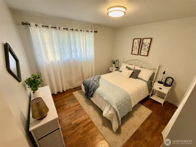 a bedroom with a bed and a chair