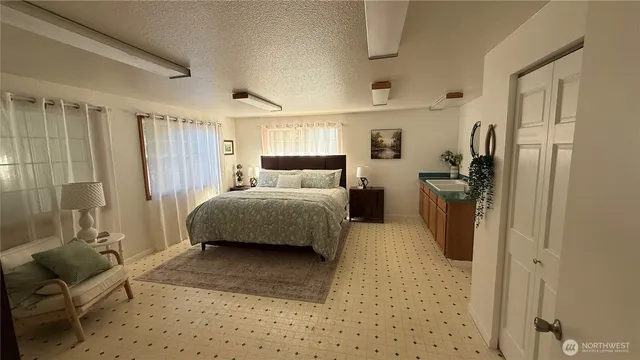 a bedroom with a bed and a couch