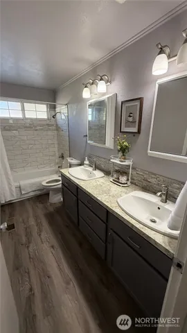 a bathroom with a double vanity sink and a mirror