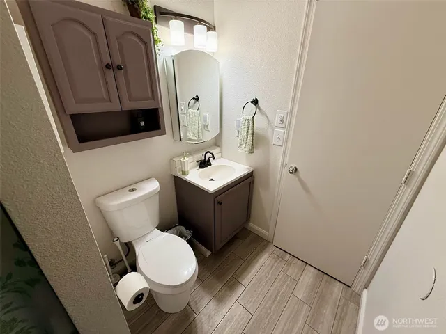 a bathroom with a toilet sink and mirror