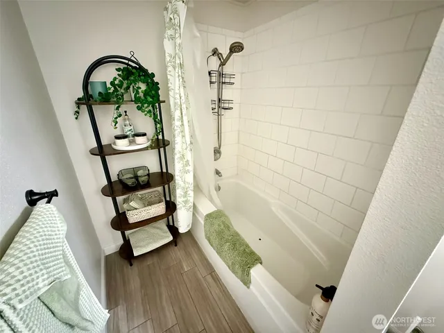 a bathroom with a sink mirror toilet and bathtub