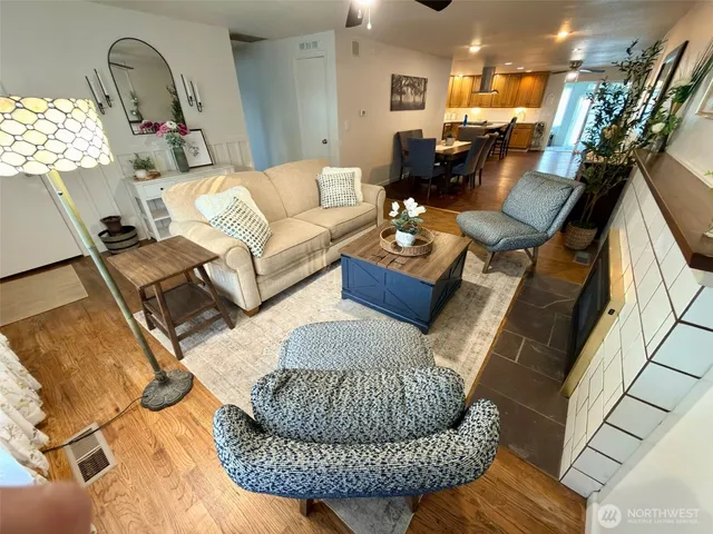 a living room with furniture gym equipment and view of kitchen