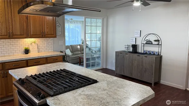 a kitchen with a stove a sink and cabinets