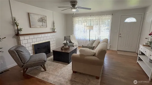 a living room with furniture fireplace and window