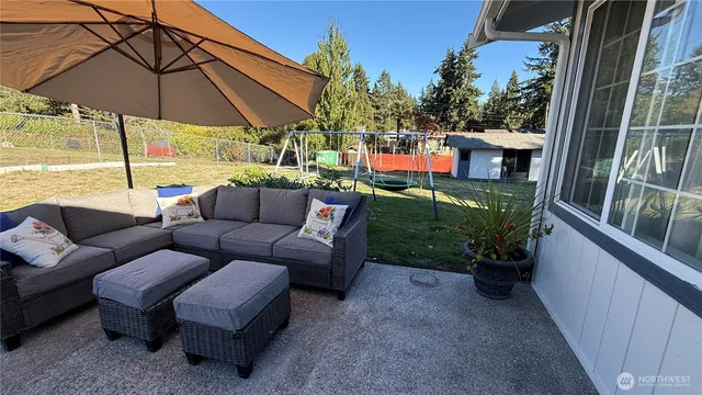 a patio with patio a table and chairs under an umbrella