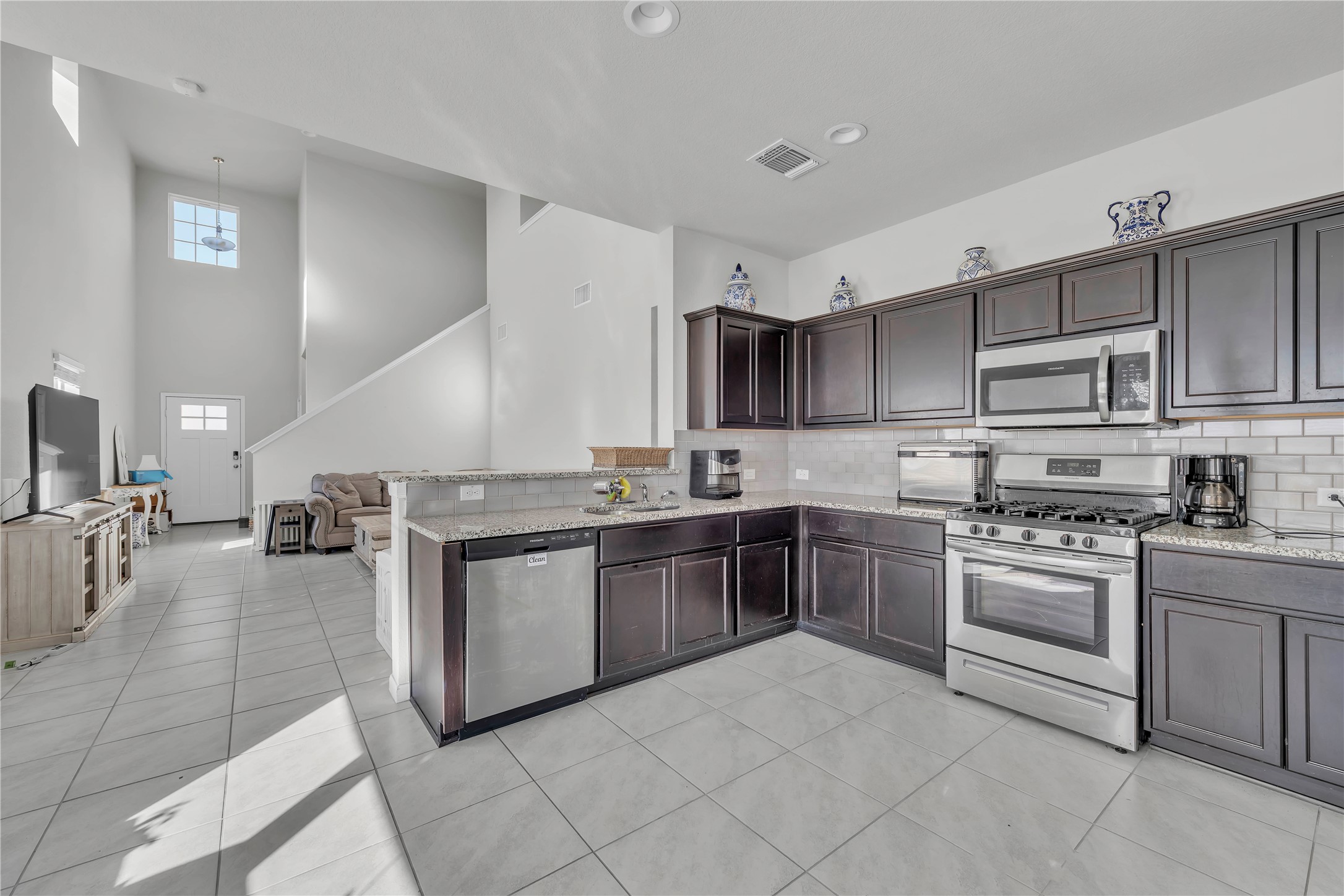 6813 Ranchito Drive Austin, TX 78744 - Photo 6 of 16 a kitchen with a stove sink and cabinets