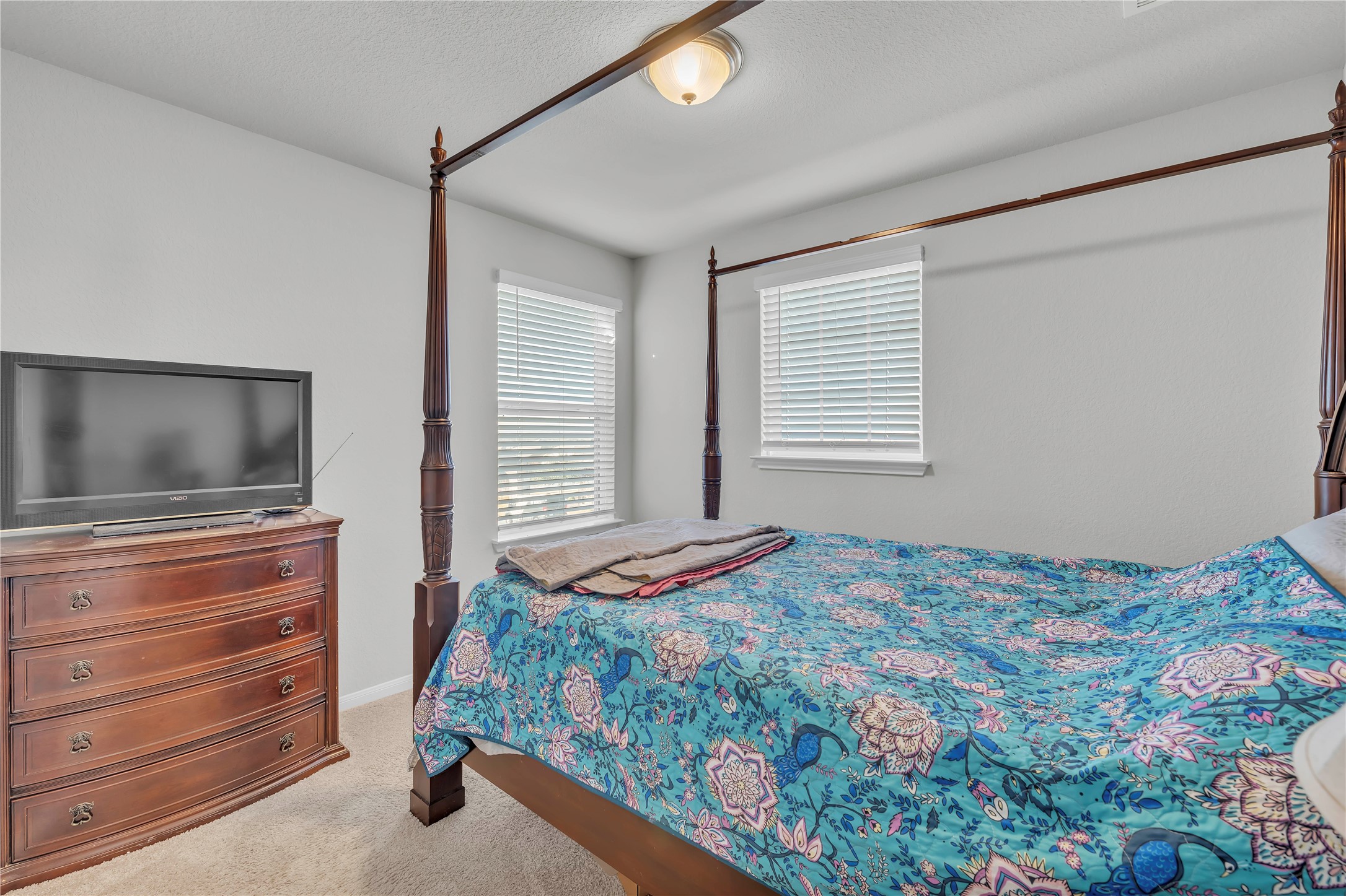 6813 Ranchito Drive Austin, TX 78744 - Photo 10 of 16 a bedroom with a bed and a flat screen tv