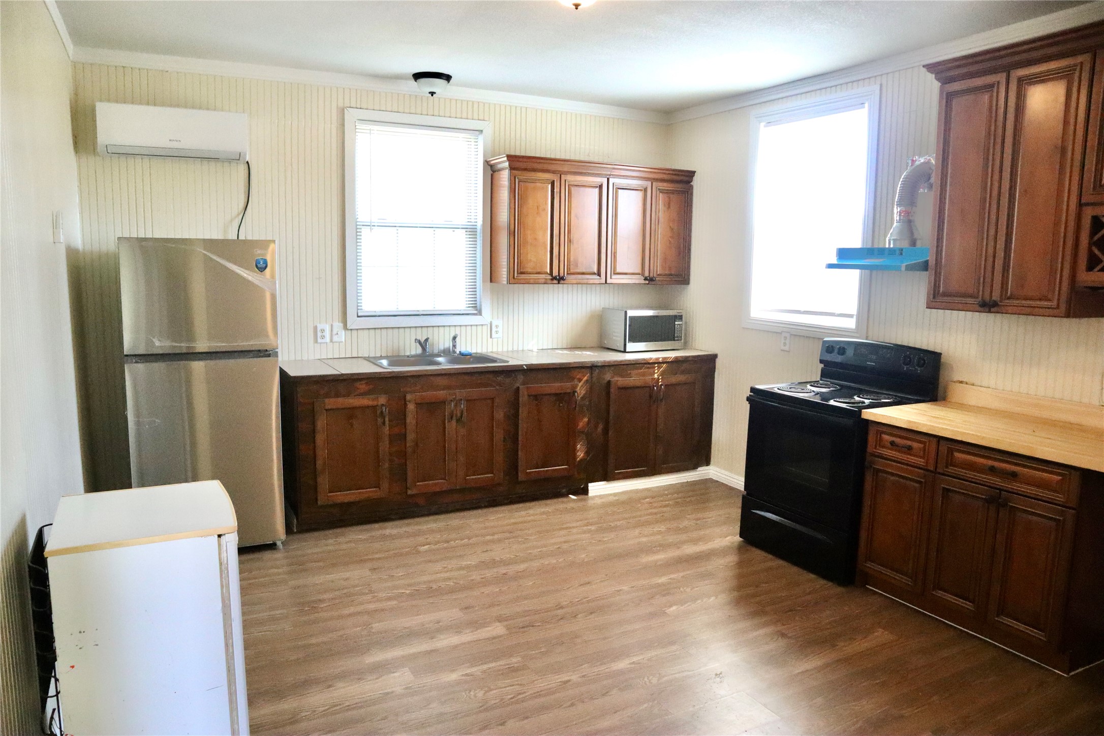2689 County Road 32 Angleton, TX 77515 - Photo 9 of 15 a kitchen with stainless steel appliances granite countertop a refrigerator a sink dishwasher a stove top oven and wooden floor