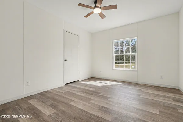 wooden floor in an empty room with a window
