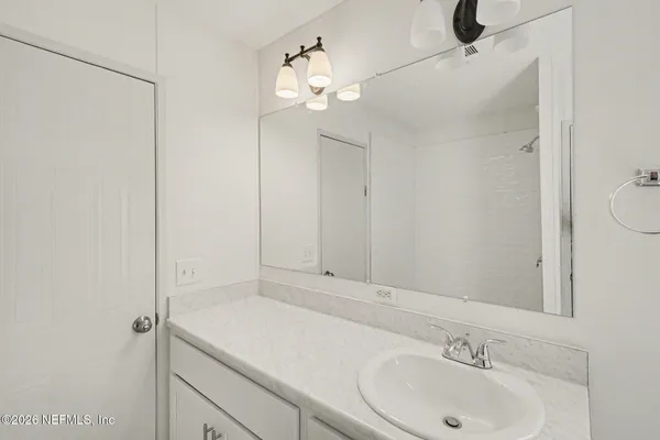 a bathroom with a sink and a mirror