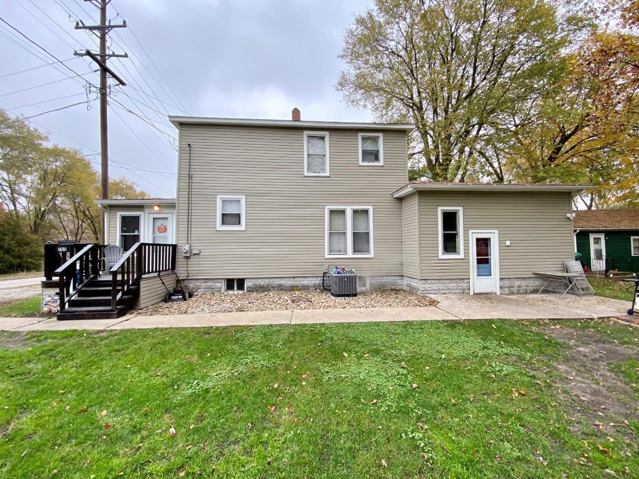 a front view of house with yard and patio
