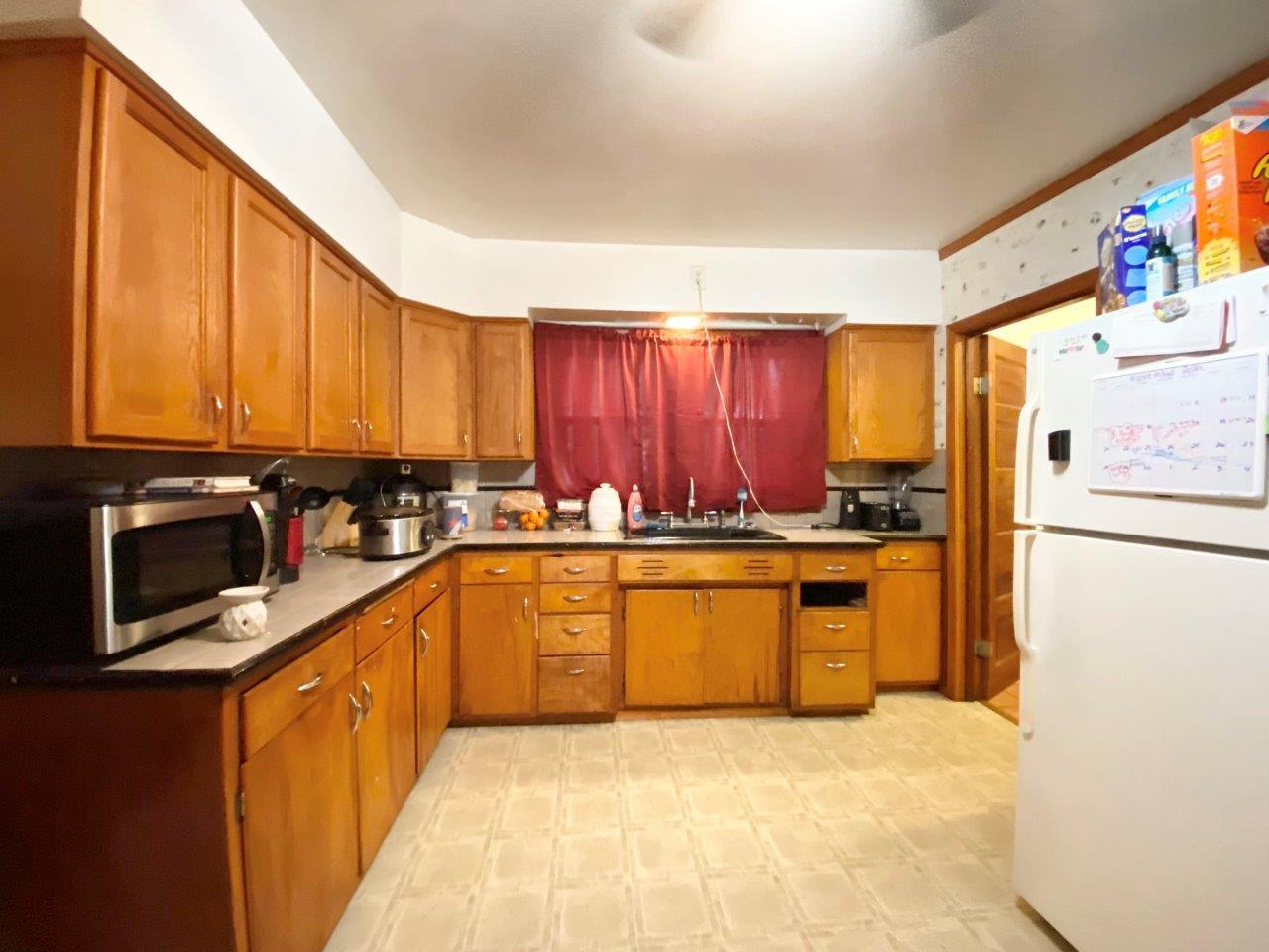 703 East Larue Street Streator, IL 61364 - Photo 13 of 38 a large kitchen with stainless steel appliances granite countertop a refrigerator a stove top oven a sink and dishwasher