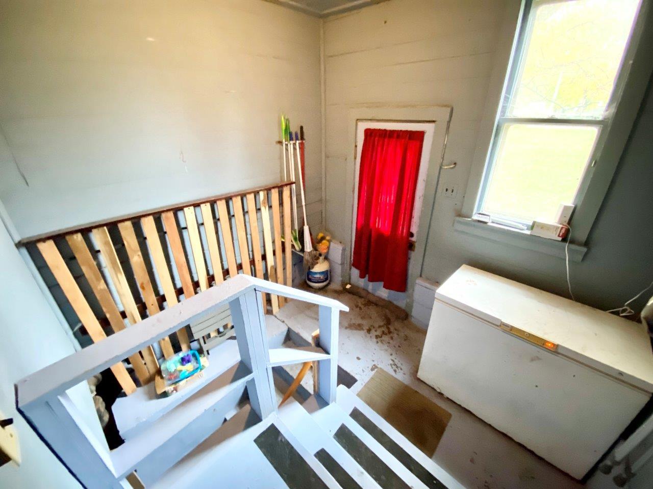 703 East Larue Street Streator, IL 61364 - Photo 24 of 38 a view of an empty room with wooden floor and furniture