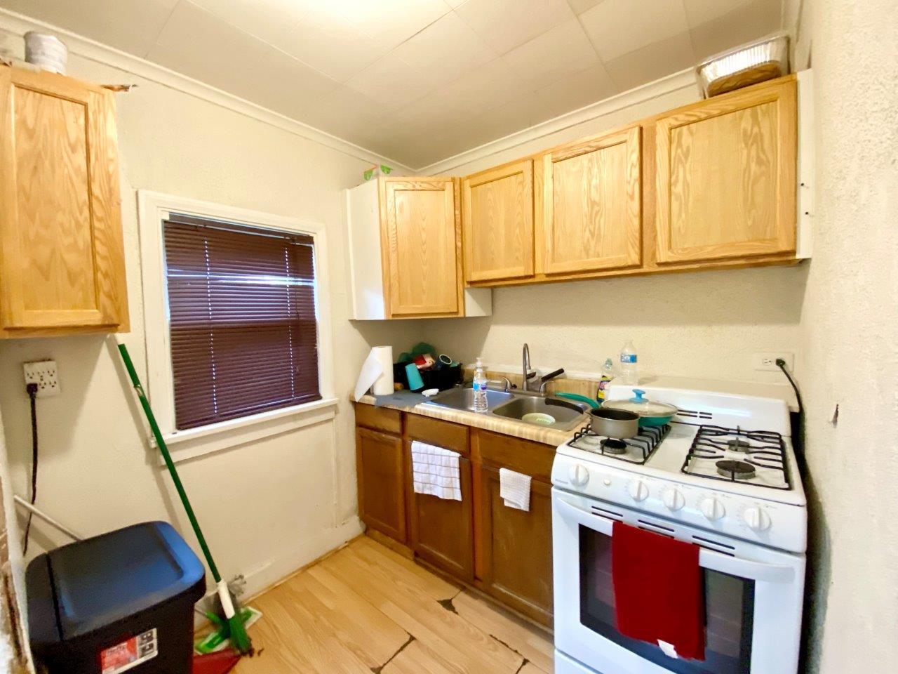 703 East Larue Street Streator, IL 61364 - Photo 28 of 38 a kitchen with a stove a sink and a microwave