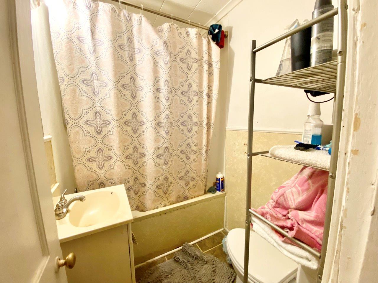 703 East Larue Street Streator, IL 61364 - Photo 31 of 38 a bathroom with a sink and a shower